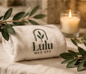 Rolled Lulu towel beside a candle